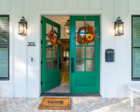 Green doors opening from a porch 