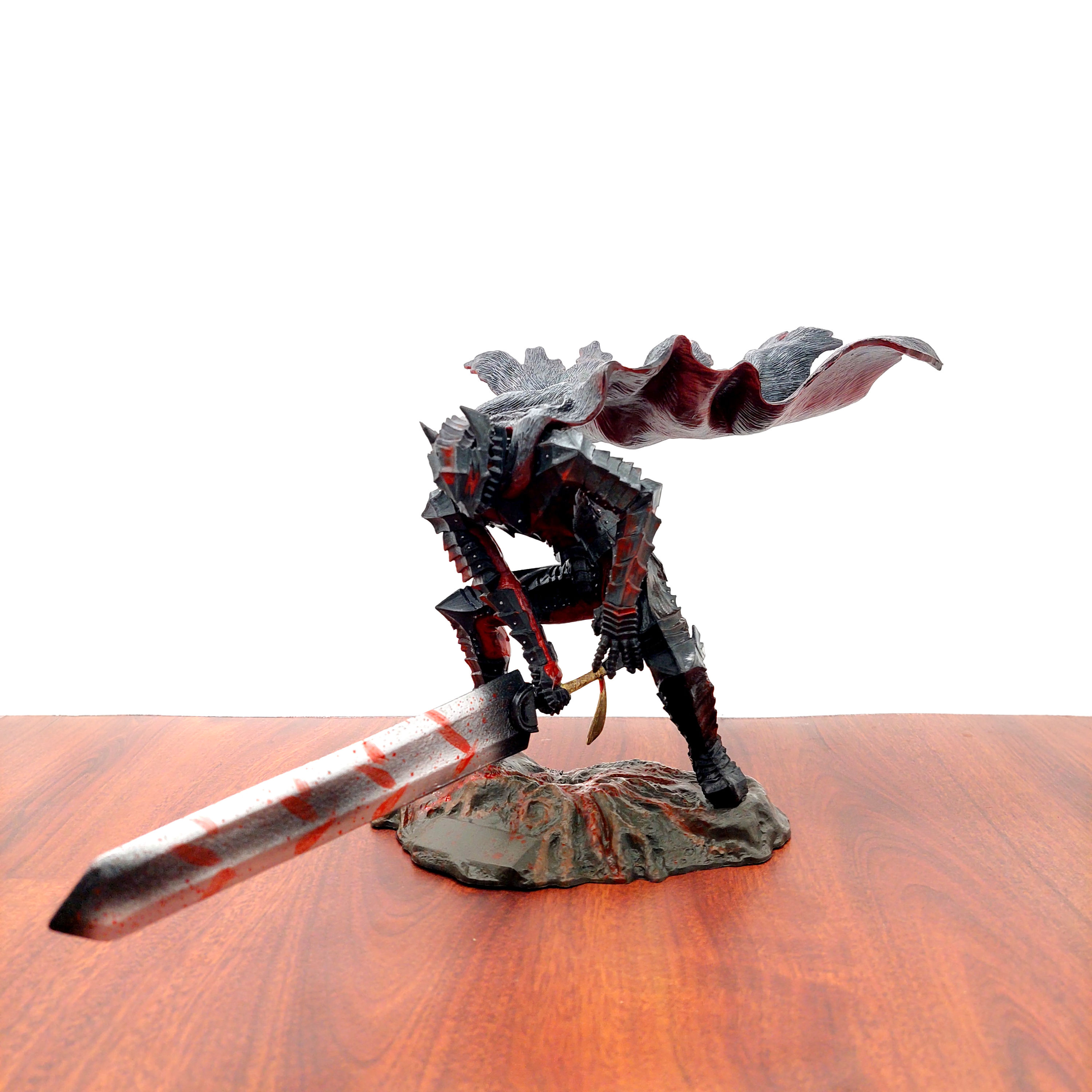 Guts figure holding massive sword, detailed pose ready for battle on brown wood table