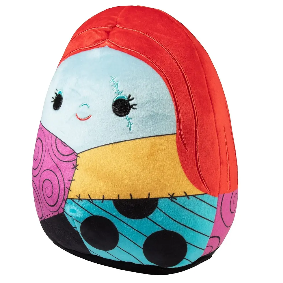 Thumbnail: Sally Squishmallow plush toy, featuring patchwork dress with red hair and face.