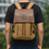 Thumbnail: Man wearing a tan and brown backpack with visible text and design on it.