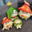 Thumbnail: Four plush toys of Genshin Impact characters sitting on a grey couch.