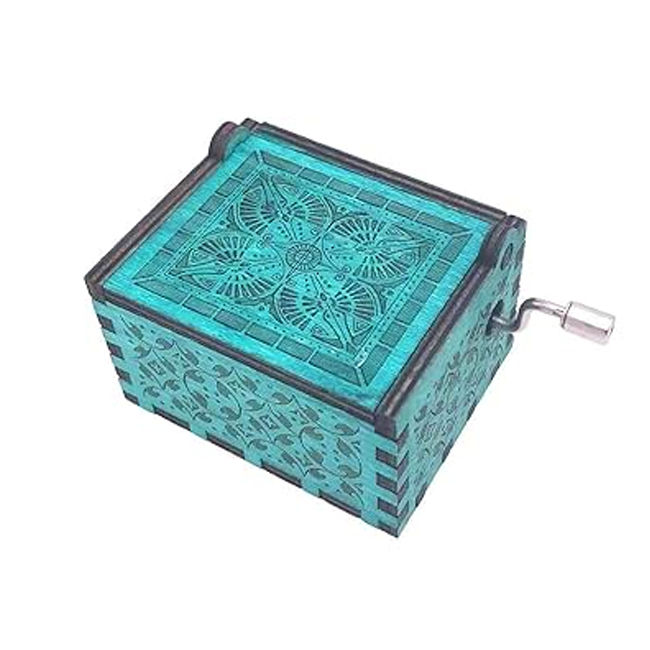 Thumbnail: Turquoise music box with intricate carvings on a white backdrop, detail.