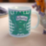 Slytherin mug. Text on mug reads Slytherin with green and white decoration.