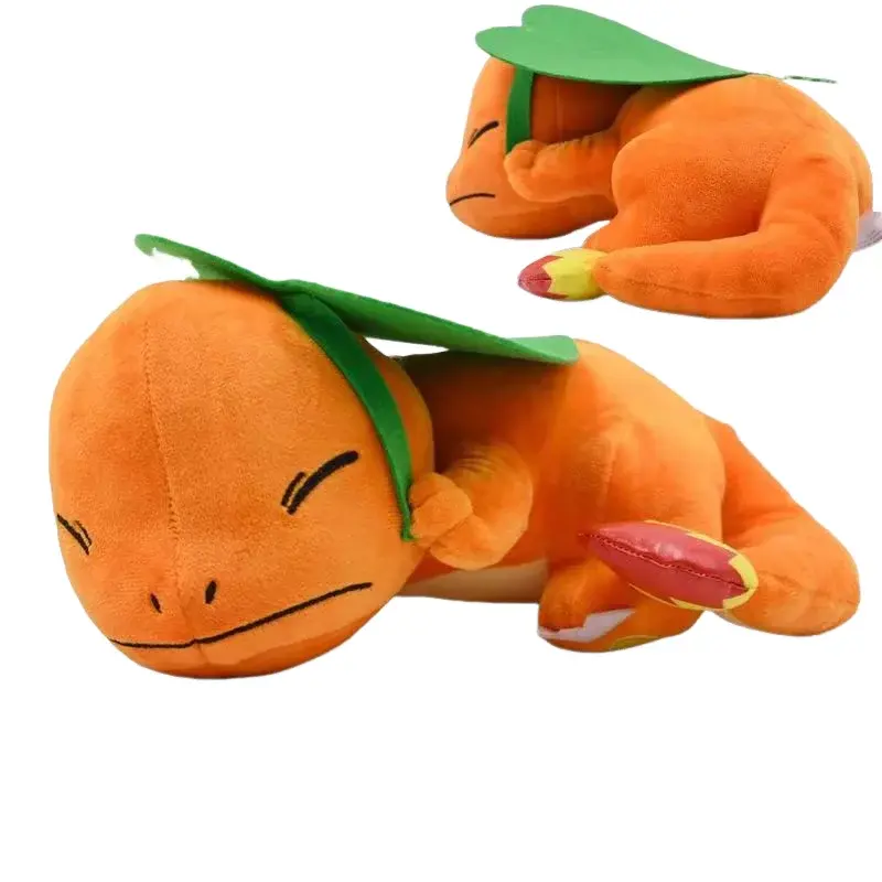 Orange charmander plush toy with green leaf on its head, sleeping pose.