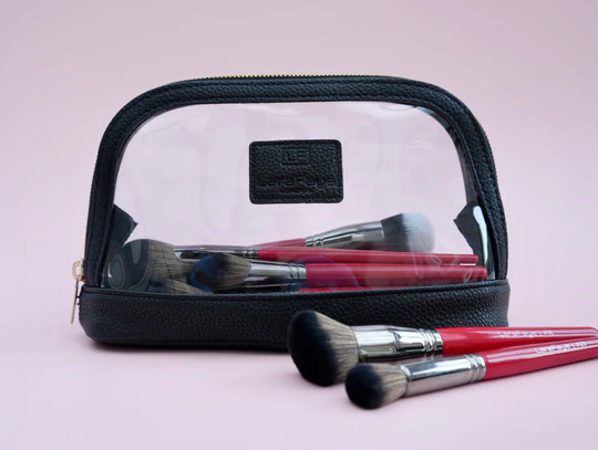 1red makeup brushes inside a clear makeup bag with black trim