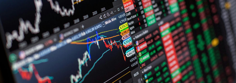 Close-up of a financial chart showing colorful stock trends and numbers on a screen. Predominant colors are red, green, and blue.