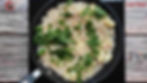 Fasting Sabudana Khichdi - Method 10 -Close-up of a pan with cooked sabudana and potatoes, topped with fresh green cilantro / coriander. Wooden surface background.