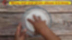 Sabudana Khichdi - Method 1 -Hand stirring tapioca pearls in clear bowl on wooden surface.