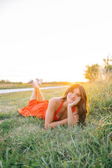 Young woman in a red dress posing at Dale Maffit Reservoir near Des Moines, Iowa