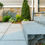 Thumbnail: A close up of a front walkway and step. The walkway and step are made out of Blue Mist Granite natural stone.