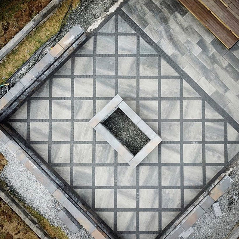 Thumbnail: Techo Bloc Everest Slab in the color Shale Grey. It is a top down view showing the patio which is a diamond square pattern
