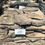 Thumbnail: A crate of about one cubic yard of Pennsylvania Garden Path Stepping Stones. A purple, brown, and earth tone colored stone.