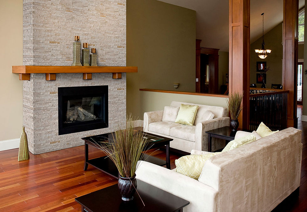 A cozy living room with cream colored furniture. The fireplace surround is veneered with MSI Rockmount Royal White Veneer.