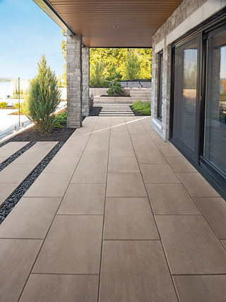 Paver manufacturer, Techo Bloc, Blu Grande paver in the color Caffe Creama, being used as a walkway leading out into a backyard that overlooks the ocean