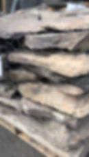 A close up of Pennsylvania PA Garden Path Stepping Stones. This brown, purple, and earth toned stone has pieces of moss on it