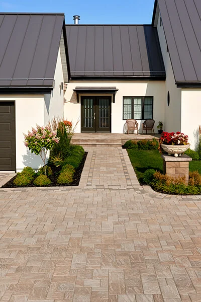 Thumbnail: Techo Bloc Eva Paver slate finish in the color Chestnut Brown being used as a driveway and continuing into a front walkway