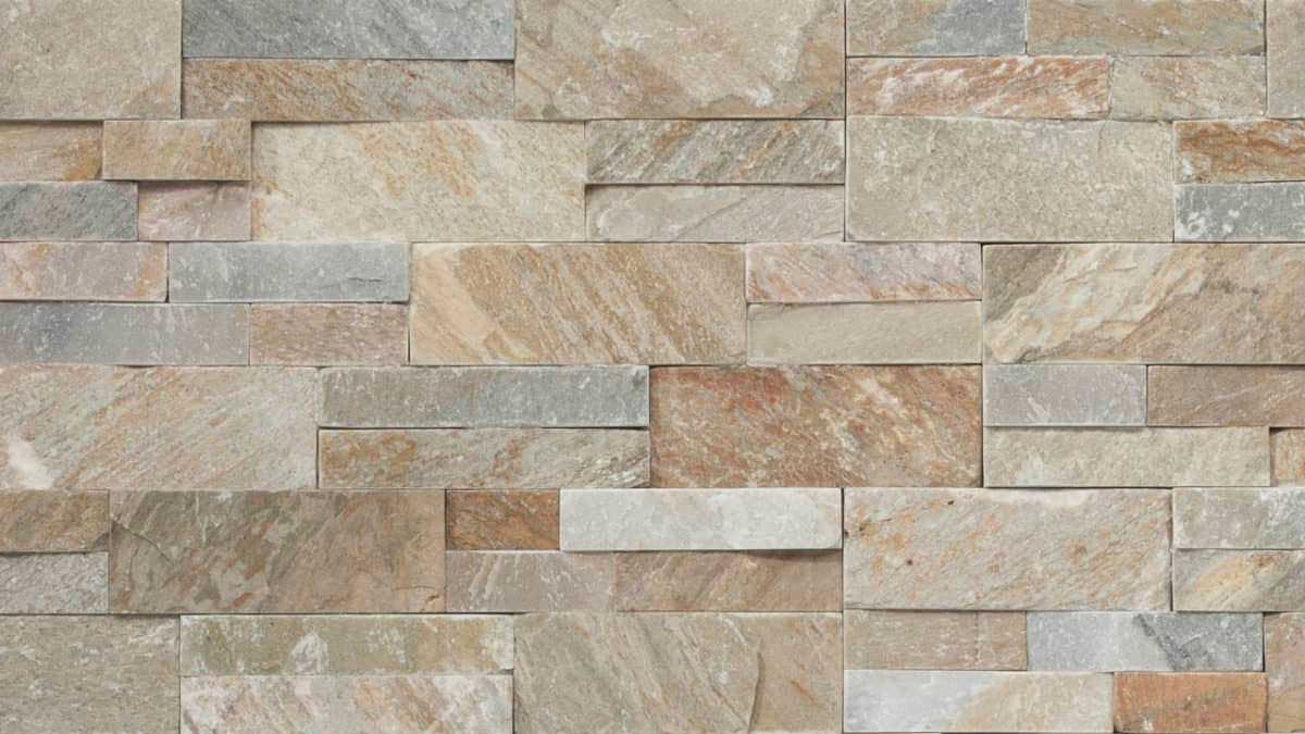 A tan, gold, and grey toned natural stone veneer ledgestone panel.