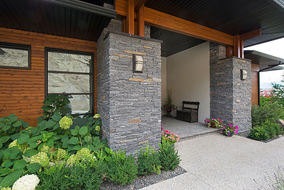 Thumbnail: A large pillar at the front of a home veneered in Pangaea's thin stone veneer in the color Westcoast, a blend of grey stone