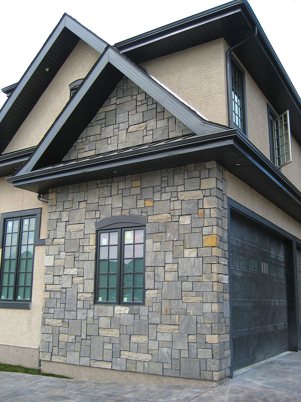 Thumbnail: A detached garage that is veneered with Cambrian Castlestone Thin Veneer Stone, a dark and light grey blended stone