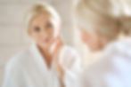 Headshot of gorgeous mid age adult 50 years old blonde woman standing in bathroom after sh