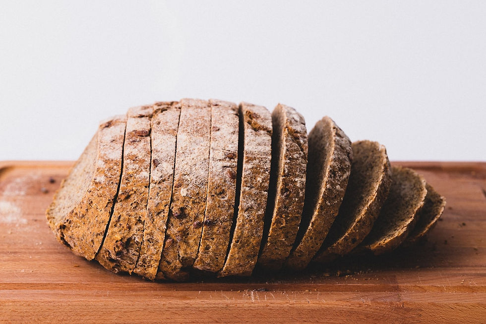 Fresh loaves of bread cooling on a bakery rack