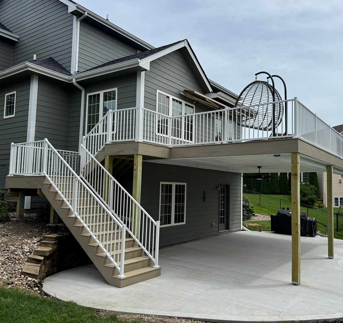 Composite deck with white Westbury railing, waterproof system, and finished ceiling built in Ankeny, Iowa (2025)