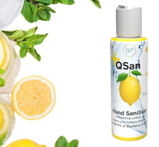 Thumbnail: The image shows a bottle of QSan hand sanitizer in the "Refreshing Lemon" scent positioned to the right, with sliced lemons, mint leaves, and a small jar of lemon-infused product decoratively placed on the left. The label features a lemon graphic and promotes the sanitizer’s ability to kill 99.9% of bacteria while softening hands. The bright yellow accents and citrus visuals evoke a clean, zesty, and invigorating feel.