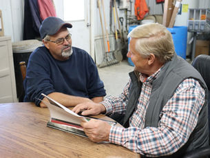 Dairy Farmer Dennis Mashek and his Maximum Farming System associate review yield and soil test information