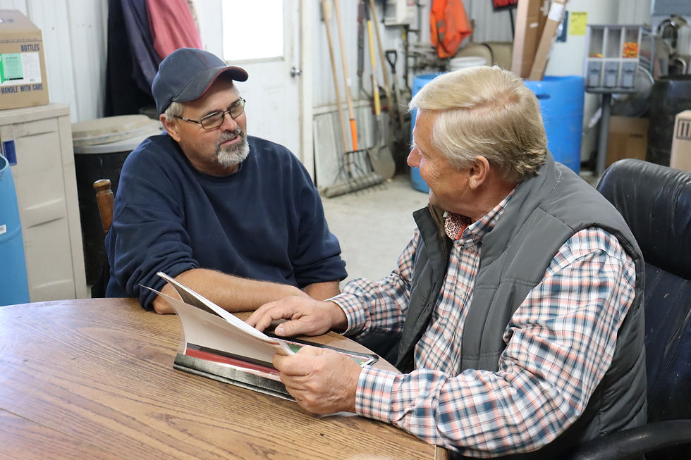 Dairy Farmer Dennis Mashek and his Maximum Farming System associate review yield and soil test information