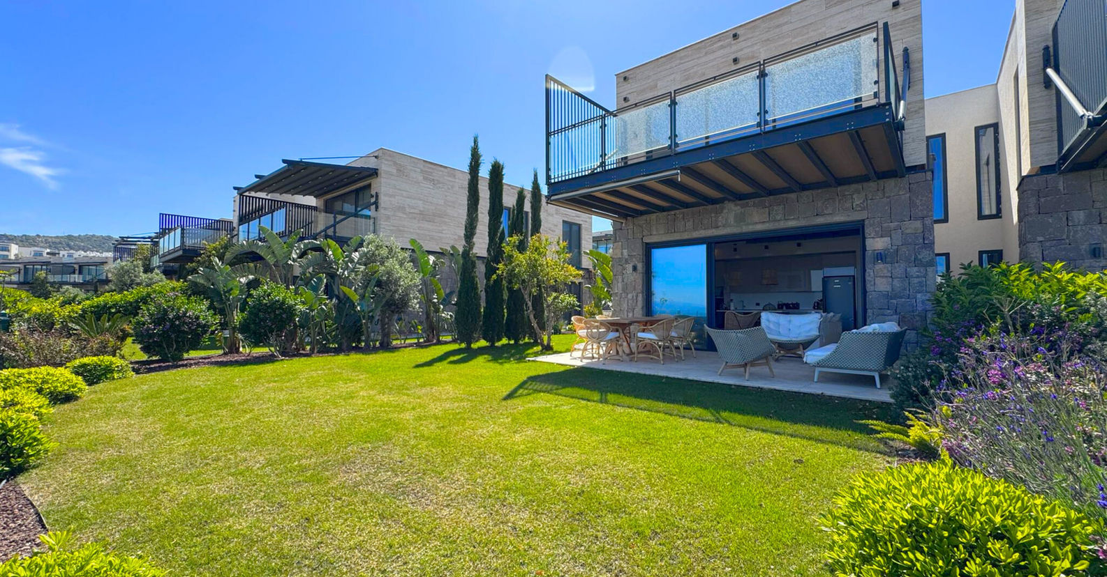 Modern luxury villa with green lawn and garden views in Bodrum.