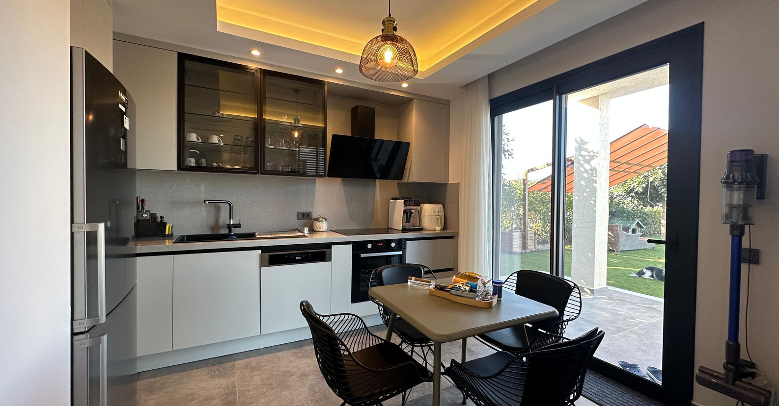 Modern kitchen and dining area with garden views in Bodrum villa.