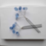 A pair of hairpins with a spray of six blue faceted crystals