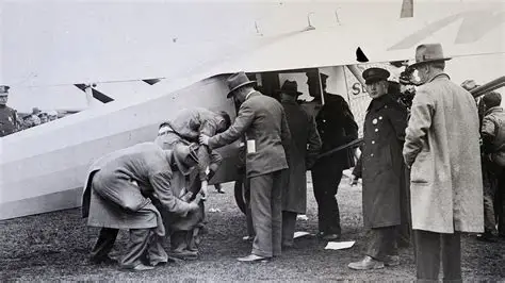 Lindbergh being greeted and assisted upon disembarking