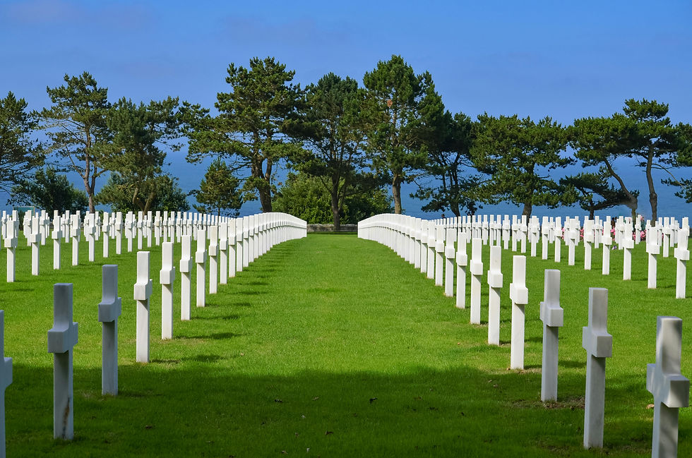 Rows of white military headstones in a World War II cemetery, honoring the soldiers who died on D‑Day