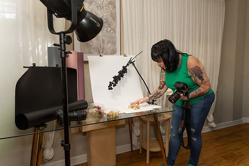 Commercial product photographer Dawn V. Gilmore working on a styled product photography set