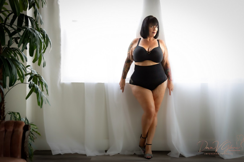 Empowering boudoir portrait with soft backlighting