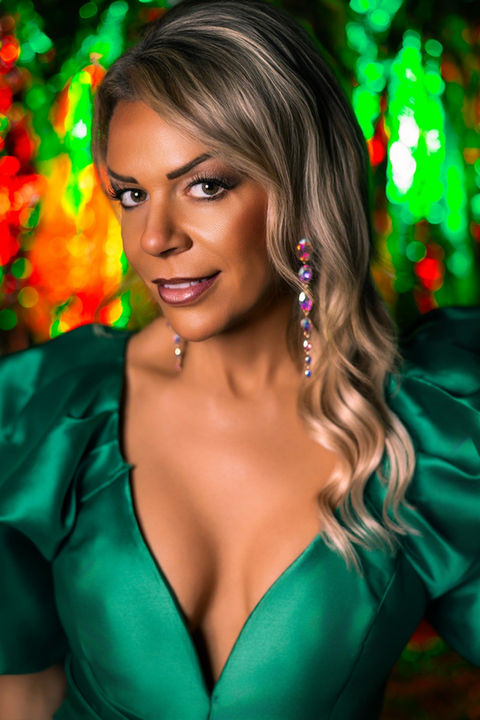 Luxury portrait of a woman in an emerald gown with dramatic lighting, photographed in Biloxi, Mississippi by Dawn V. Gilmore VIP Photography.