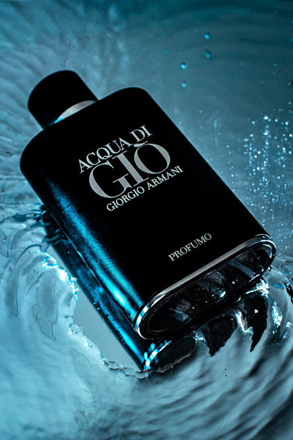 Luxury product photo of Armani Acqua di Giò Profumo cologne resting in textured water with blue lighting and dramatic ripples by Dawn V Gilmore VIP Photo.