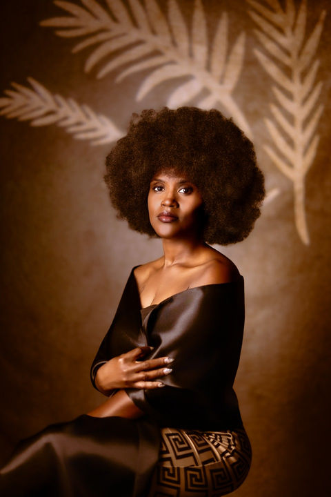 Luxury editorial portrait with soft glam and gold accents, captured at Dawn V. Gilmore’s Biloxi studio.