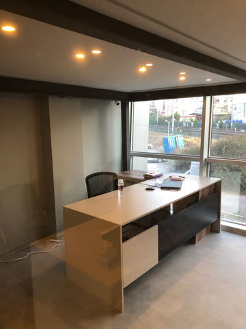 A dedicated two-person accounting office is located on the lower floor. Ergonomically designed desks and functional storage units ensure a comfortable and organized workspace. The use of neutral tones and simple decor creates a professional yet calming atmosphere.