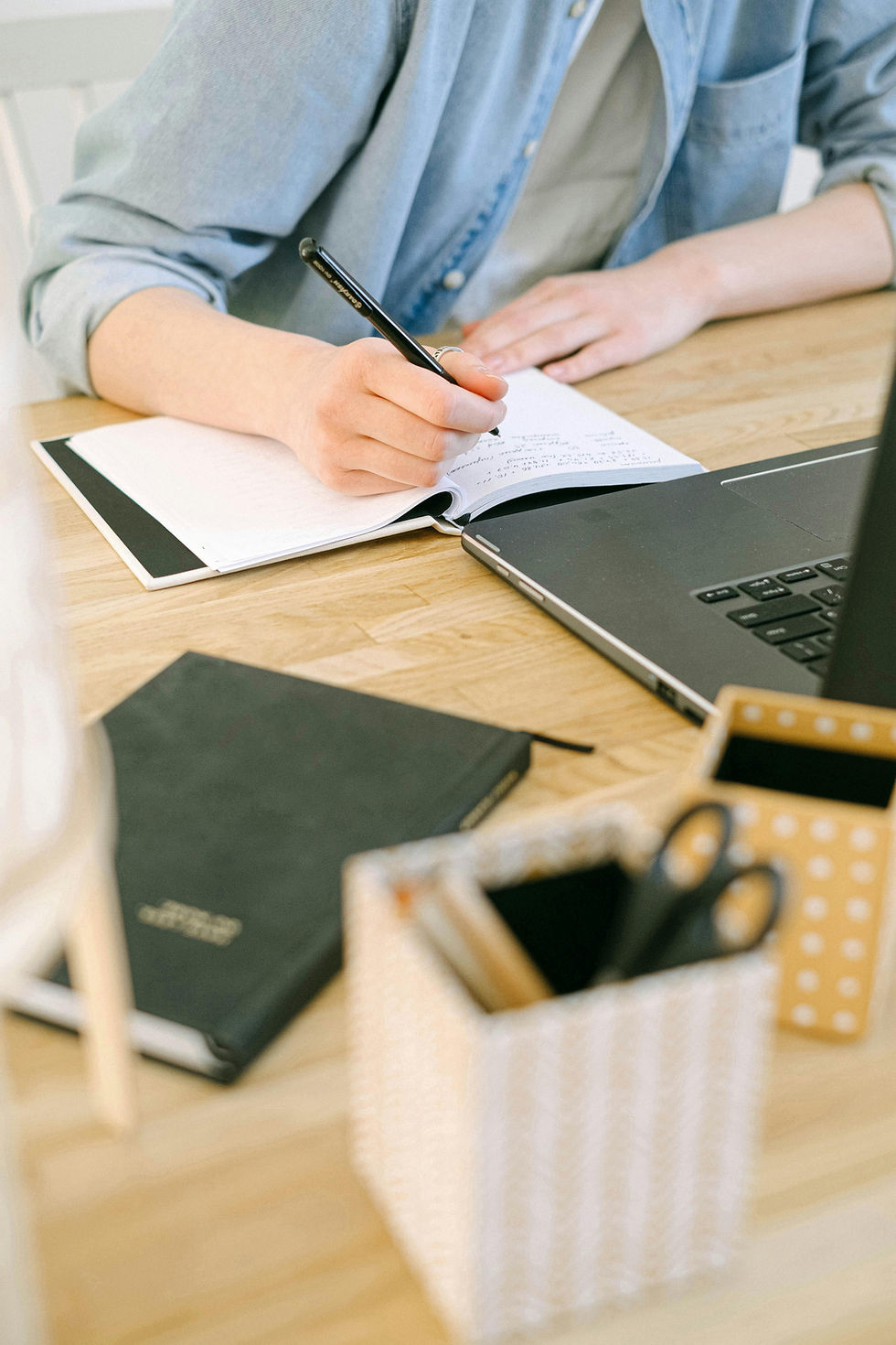person writing at desk