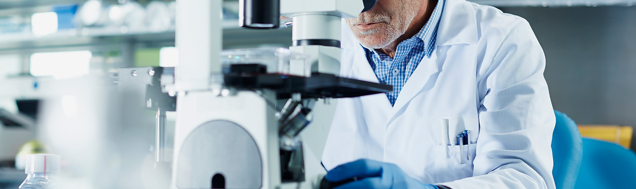 Scientist using microscope