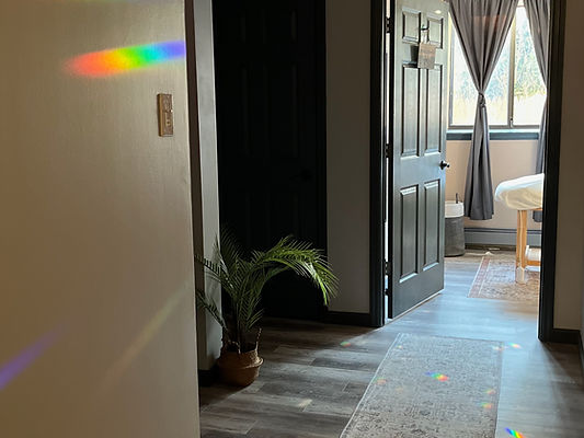 Natural light and rainbow refractions in a hallway at Prism Acupuncture, offering a calm and welcoming healing space