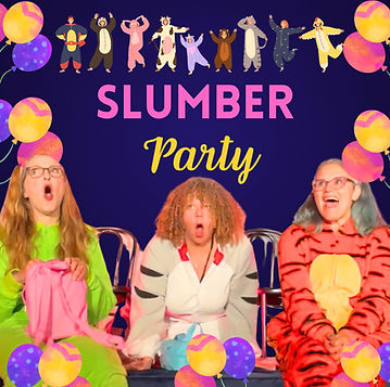 Three adult women in onesies - a cow, frog, and raccoon - as if they are at a slumber party. They are at the edge of a stage.