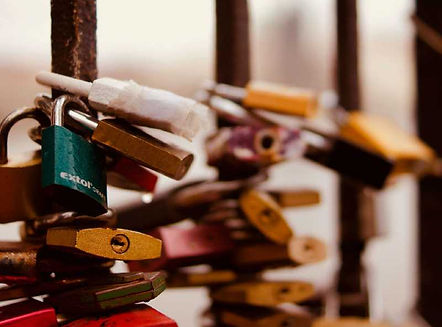 Several locks wrapped around an iron gate.