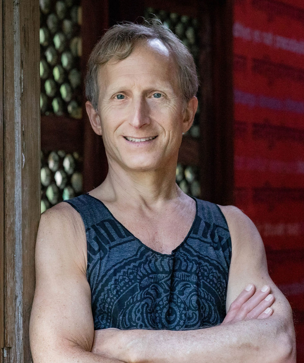 picture of Todd Norian standing against a lattice wall with arms crossed