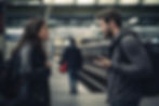 man and woman arguing on a subway station platform