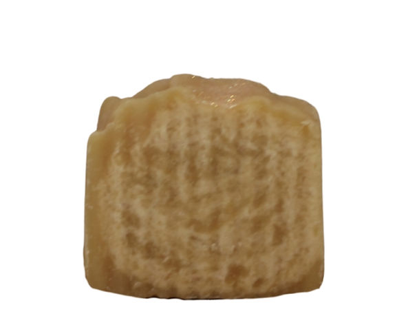 Handcrafted beer bar soap with a creamy beige tone and gently textured top, made using cold process ingredients and displayed on a clean white background