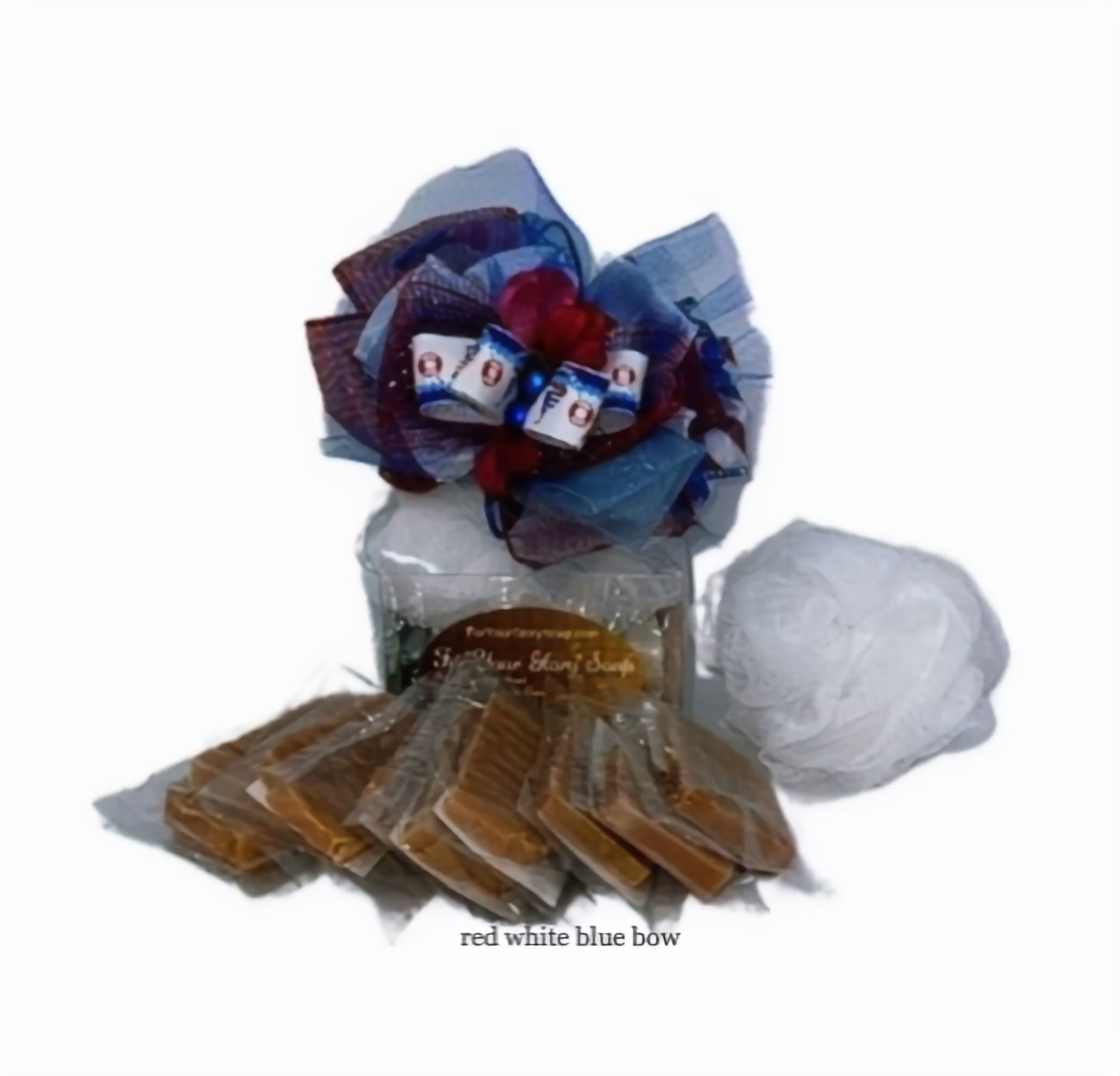 Artisan mini travel soaps with decorative bow and small mesh sponge in gift packaging