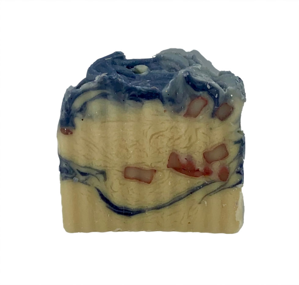 A handmade soap bar with a wavy blue and cream pattern, featuring red chunks. The background is plain white.